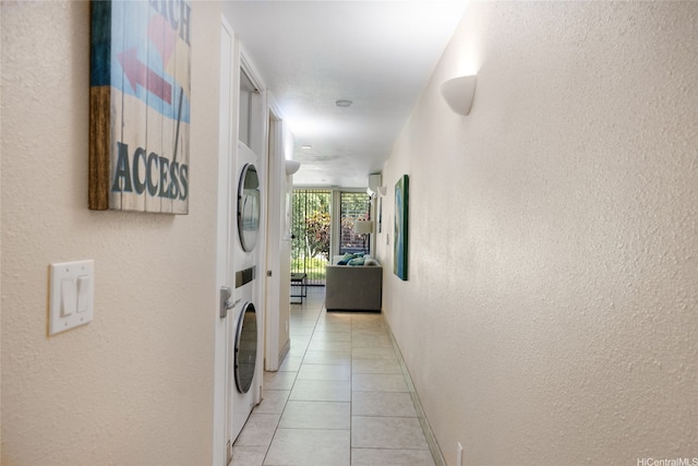 57-91 Lalo Kuilima Pl Unit 5/47, Kahuku, HI 96731 - laundry area featuring estacked washer and dryer, light tile patterned flooring, and a textured wall