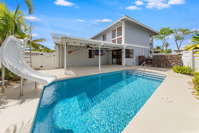 91-1011 Aeoia St Unit A, Ewa Beach, HI 96706 - view of swimming pool with a water slide, a pergola, a patio, ceiling fan, and a fenced backyard