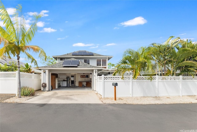 91-1011 Aeoia St Unit A, Ewa Beach, HI 96706 - view of front of home featuring roof mounted solar panels, a shingled roof, driveway, and an attached garage