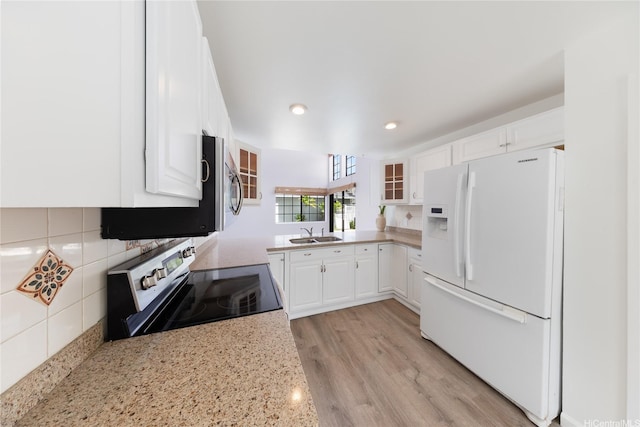 91-1011 Aeoia St Unit A, Ewa Beach, HI 96706 - kitchen featuring stainless steel appliances, a sink, white cabinets, recessed lighting, and light stone counters