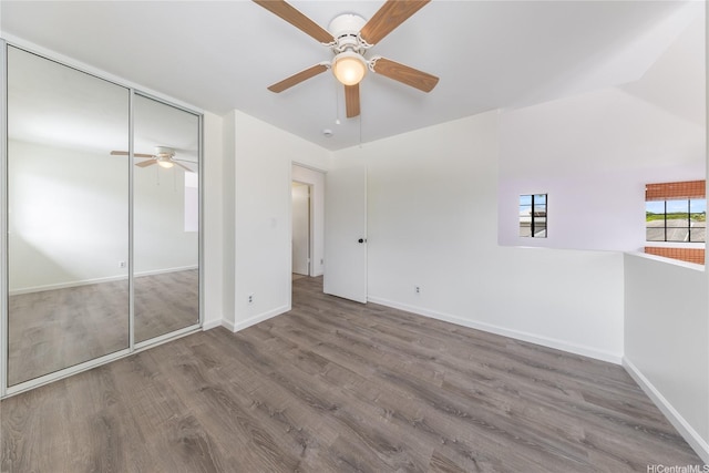 91-1011 Aeoia St Unit A, Ewa Beach, HI 96706 - unfurnished bedroom featuring wood finished floors, baseboards, a closet, and ceiling fan