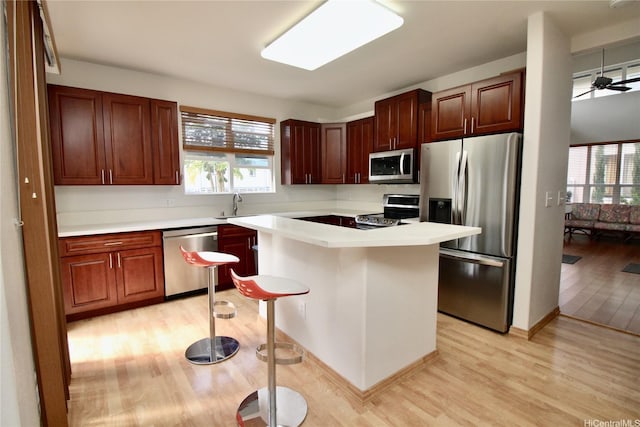 91-1066 Lanakoi St, Kapolei, HI 96707 - kitchen with stainless steel appliances, light wood finished floors, healthy amount of natural light, and light countertops