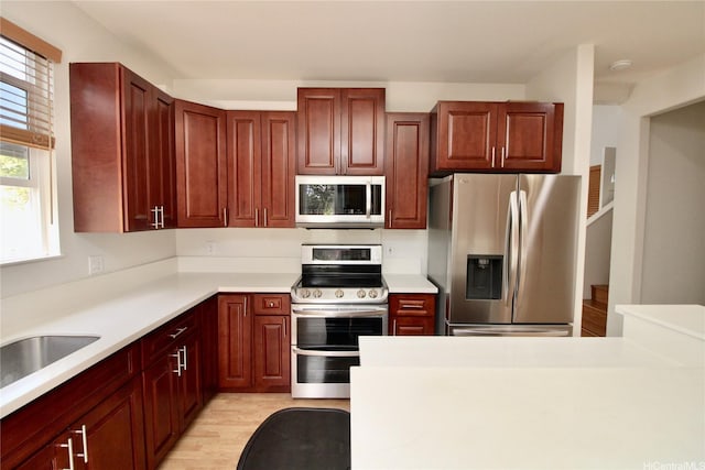 91-1066 Lanakoi St, Kapolei, HI 96707 - kitchen with stainless steel appliances, light wood-type flooring, light countertops, and a sink