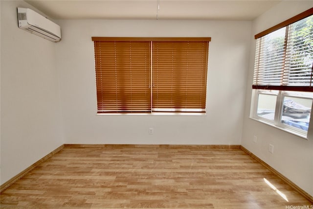 91-1066 Lanakoi St, Kapolei, HI 96707 - spare room featuring an AC wall unit, light wood-type flooring, and baseboards