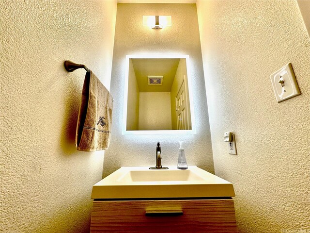 91-1066 Lanakoi St, Kapolei, HI 96707 - bathroom featuring a textured wall and vanity