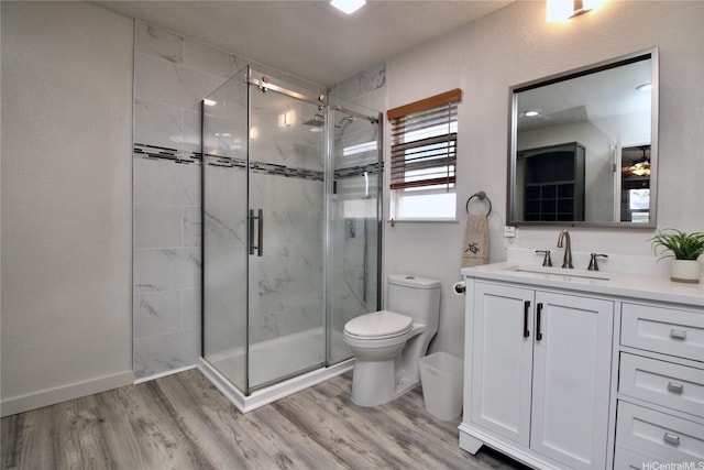 91-1066 Lanakoi St, Kapolei, HI 96707 - bathroom with toilet, vanity, wood finished floors, a shower stall, and baseboards