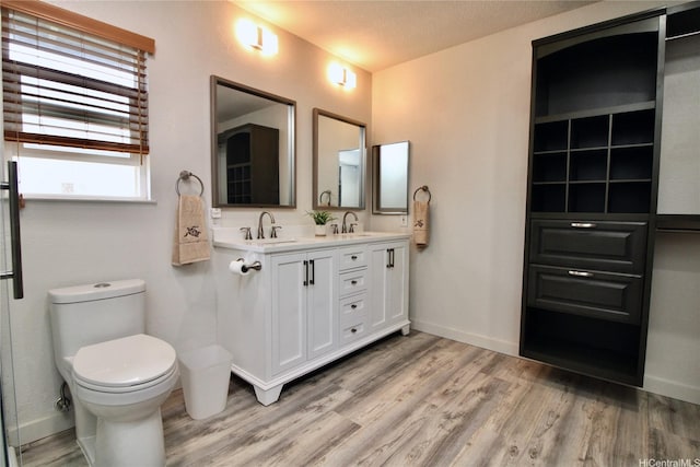 91-1066 Lanakoi St, Kapolei, HI 96707 - full bathroom with wood finished floors, double vanity, toilet, and baseboards