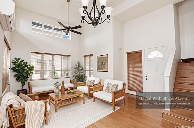 91-1066 Lanakoi St, Kapolei, HI 96707 - living room featuring wood finished floors, stairway, ceiling fan, a chandelier, and a high ceiling