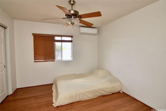 91-1066 Lanakoi St, Kapolei, HI 96707 - bedroom with a wall mounted air conditioner, wood finished floors, ceiling fan, and baseboards