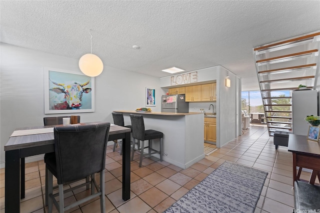 3030 Pualei Cir Unit 311, Honolulu, HI 96815 - dining room featuring a textured ceiling and light tile patterned floors