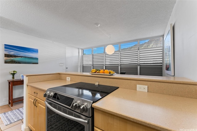 3030 Pualei Cir Unit 311, Honolulu, HI 96815 - kitchen featuring stainless steel electric range, light tile patterned floors, light countertops, and a textured ceiling
