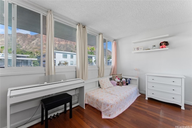 3030 Pualei Cir Unit 311, Honolulu, HI 96815 - bedroom with a textured ceiling and dark wood finished floors