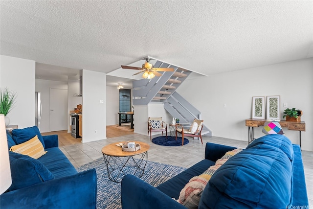 95-112 Kipapa Dr Unit 418, Mililani, HI 96789 - living room with stairway, light tile patterned flooring, a textured ceiling, and a ceiling fan