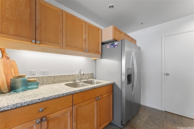 95-112 Kipapa Dr Unit 418, Mililani, HI 96789 - kitchen with stainless steel fridge with ice dispenser, light stone counters, dark tile patterned floors, and brown cabinetry