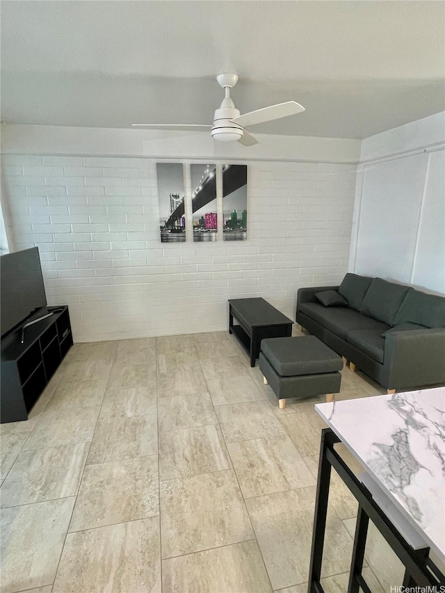 410 Nahua St Unit 106, Honolulu, HI 96815 - living area featuring ceiling fan and concrete block wall