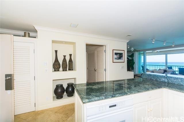2877 Kalakaua Ave Unit 505/506, Honolulu, HI 96815 - kitchen featuring crown molding, white cabinetry, dark stone countertops, light tile patterned floors, and baseboards