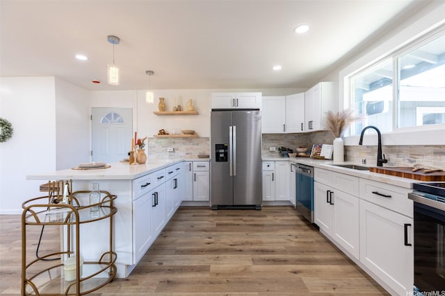 91-1327 Imelda St, Ewa Beach, HI 96706 - kitchen with stainless steel appliances, a sink, a peninsula, tasteful backsplash, and recessed lighting