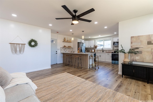 91-1327 Imelda St, Ewa Beach, HI 96706 - living room with a ceiling fan, light wood-style floors, recessed lighting, and baseboards