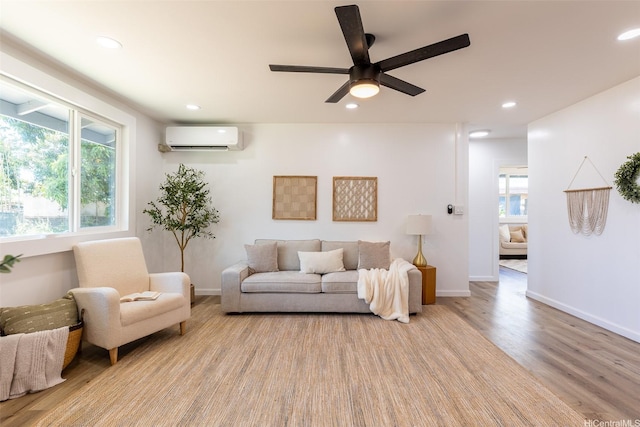 91-1327 Imelda St, Ewa Beach, HI 96706 - living area with an AC wall unit, wood finished floors, a ceiling fan, recessed lighting, and baseboards