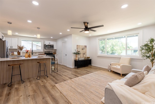 91-1327 Imelda St, Ewa Beach, HI 96706 - living area featuring light wood-type flooring, recessed lighting, baseboards, and a ceiling fan
