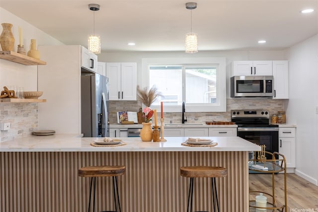 91-1327 Imelda St, Ewa Beach, HI 96706 - kitchen featuring appliances with stainless steel finishes, a peninsula, open shelves, decorative backsplash, and recessed lighting