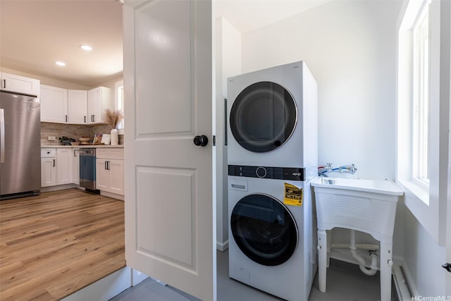 91-1327 Imelda St, Ewa Beach, HI 96706 - washroom with estacked washer and dryer, light wood-style flooring, and recessed lighting