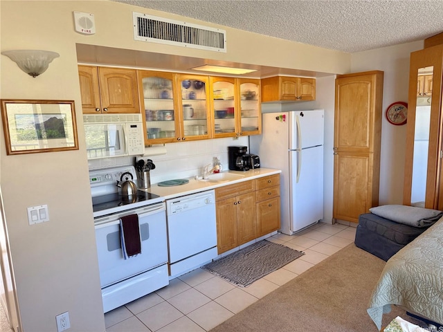 84-680 Kili Dr Unit 1001, Waianae, HI 96792 - kitchen featuring white appliances, a sink, glass insert cabinets, light countertops, and a textured ceiling