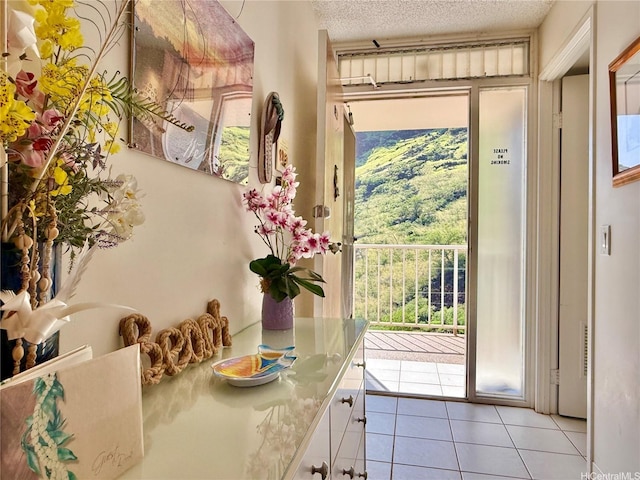84-680 Kili Dr Unit 1001, Waianae, HI 96792 - doorway to outside with light tile patterned floors and a textured ceiling