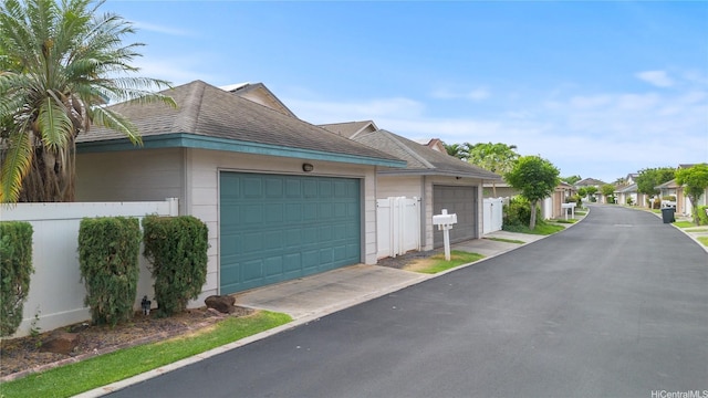 91-1022 Kaikauhaa St, Ewa Beach, HI 96706 - view of side of home featuring roof with shingles