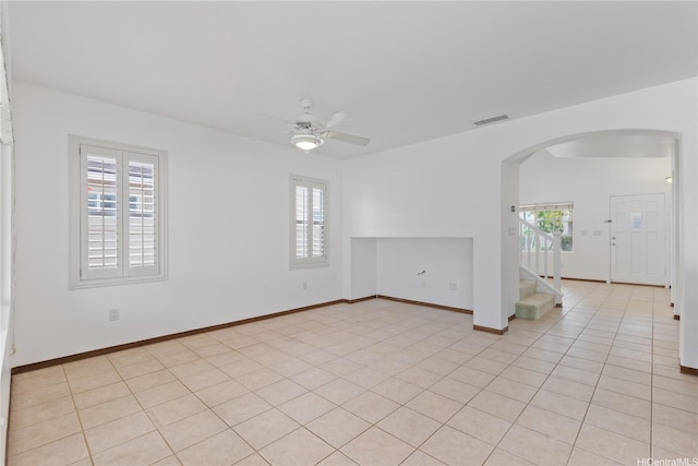 91-1022 Kaikauhaa St, Ewa Beach, HI 96706 - spare room featuring arched walkways, plenty of natural light, a ceiling fan, and stairway