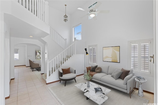 91-1022 Kaikauhaa St, Ewa Beach, HI 96706 - living area featuring a high ceiling, stairs, light tile patterned floors, a ceiling fan, and arched walkways