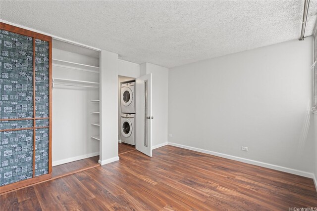 500 University Ave Unit 509, Honolulu, HI 96826 - unfurnished bedroom featuring stacked washer / drying machine, a textured ceiling, wood finished floors, and baseboards
