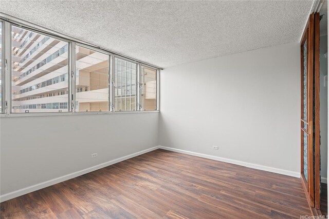 500 University Ave Unit 509, Honolulu, HI 96826 - unfurnished room with wood finished floors, baseboards, and a textured ceiling