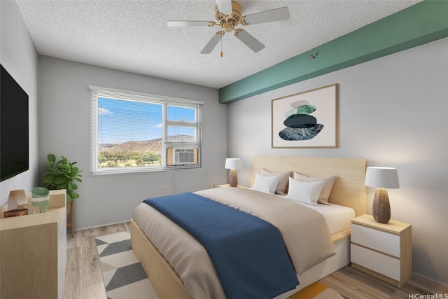 3009 Ala Makahala Pl Unit 905, Honolulu, HI 96818 - bedroom with light wood-style flooring, a textured ceiling, cooling unit, and ceiling fan