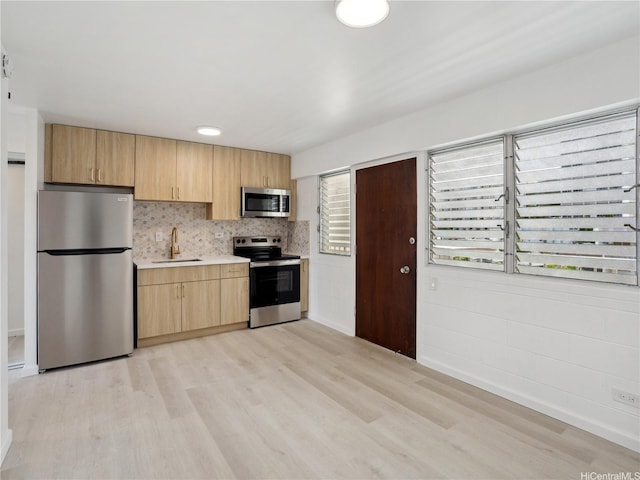 1620 Keeaumoku St Unit 506, Honolulu, HI 96822 - kitchen with stainless steel appliances, a sink, light wood-style flooring, and light countertops