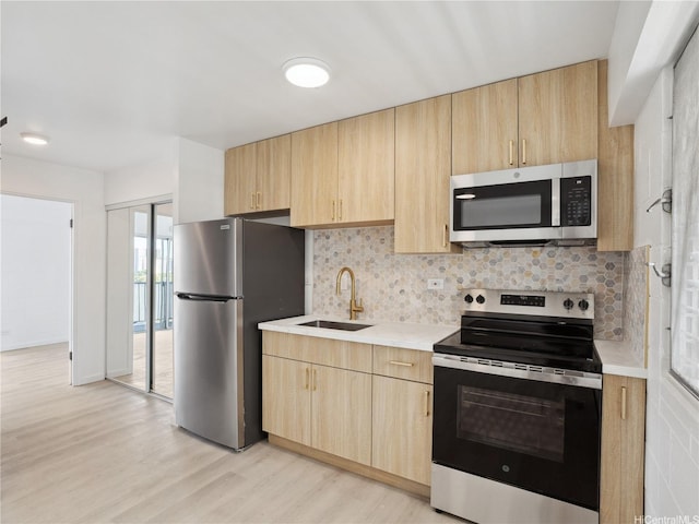 1620 Keeaumoku St Unit 506, Honolulu, HI 96822 - kitchen with stainless steel appliances, light brown cabinets, a sink, and light countertops