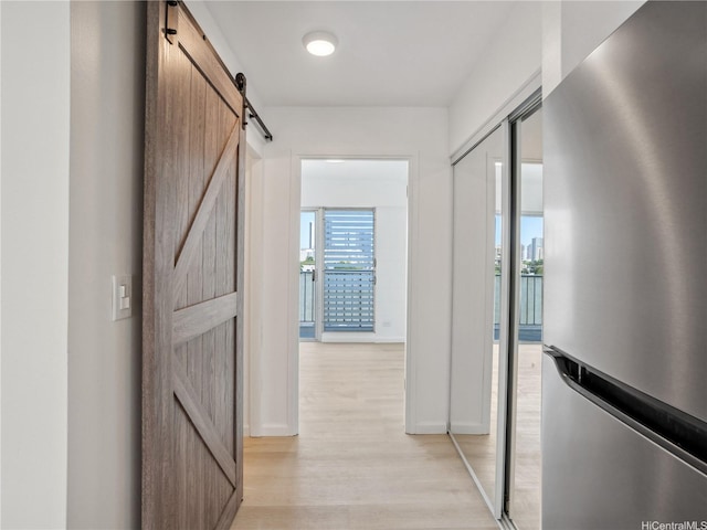 1620 Keeaumoku St Unit 506, Honolulu, HI 96822 - corridor with a barn door, light wood-style flooring, and baseboards