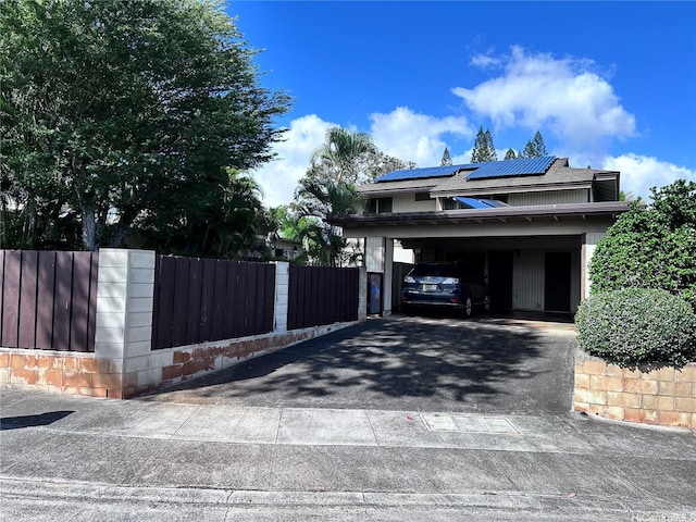 94-070 Akualele Pl, Mililani, HI 96789 - view of home's exterior with asphalt driveway, a carport, and roof mounted solar panels