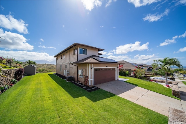 92-735 Welo St, Kapolei, HI 96707 - view of front facade with solar panels, concrete driveway, an attached garage, and central AC