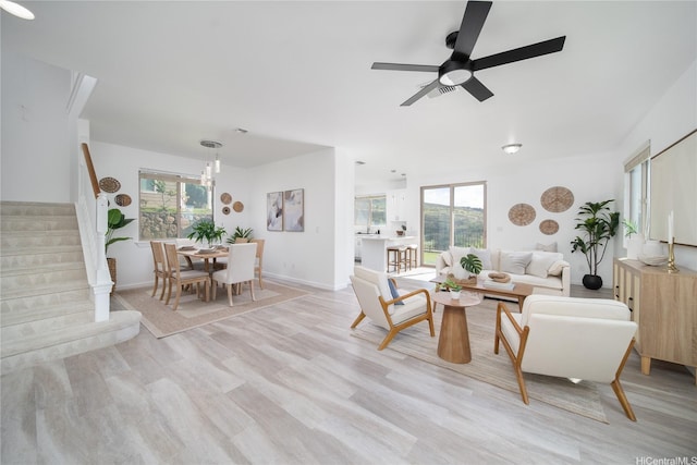 92-735 Welo St, Kapolei, HI 96707 - living room with stairway, healthy amount of natural light, light wood finished floors, and baseboards