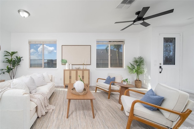 92-735 Welo St, Kapolei, HI 96707 - living room with healthy amount of natural light, a ceiling fan, baseboards, and light wood-type flooring