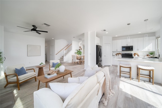 92-735 Welo St, Kapolei, HI 96707 - living room with stairs, light wood-style flooring, recessed lighting, and ceiling fan