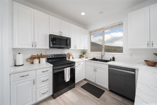 92-735 Welo St, Kapolei, HI 96707 - kitchen with black range with electric cooktop, dishwasher, a sink, white cabinets, and recessed lighting