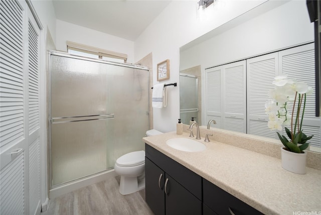 92-735 Welo St, Kapolei, HI 96707 - bathroom with a closet, toilet, wood finished floors, and a shower stall