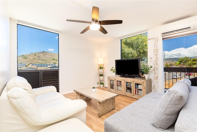 1005 Ala Lilikoi St Unit W201, Honolulu, HI 96818 - living area featuring light wood-type flooring, ceiling fan, and a wall unit AC
