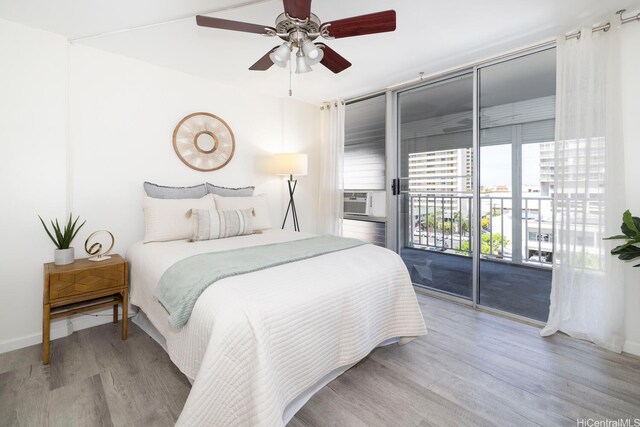 475 Atkinson Dr Unit 608, Honolulu, HI 96814 - bedroom featuring access to outside, wood finished floors, cooling unit, a ceiling fan, and baseboards