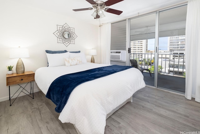 475 Atkinson Dr Unit 608, Honolulu, HI 96814 - bedroom featuring access to exterior, wood finished floors, cooling unit, and baseboards