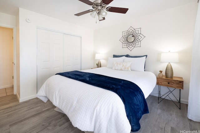 475 Atkinson Dr Unit 608, Honolulu, HI 96814 - bedroom featuring wood finished floors, a closet, baseboards, and a ceiling fan