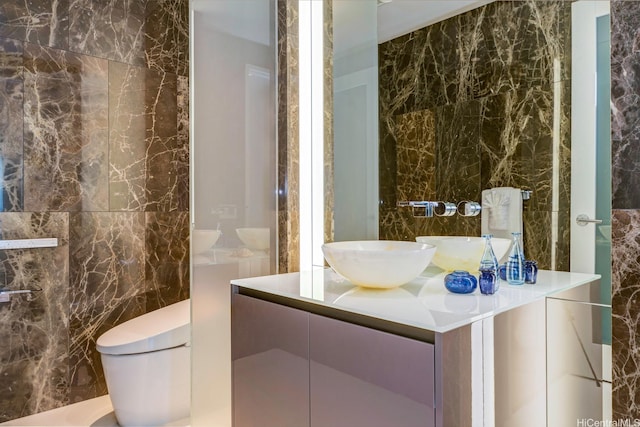 1118 Ala Moana Blvd Unit 1000, Honolulu, HI 96814 - bathroom featuring toilet, vanity, and tile walls