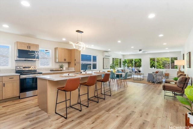 1504 Ainakoa Ave, Honolulu, HI 96821 - kitchen with stainless steel appliances, light brown cabinetry, open floor plan, an island with sink, and recessed lighting